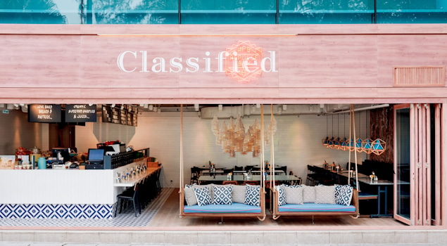 Classified Hong Kong is more than a dining experience; it's an architectural masterpiece that engages all the senses. Our inspiration drew from the café's coastal surroundings, translating into an architectural marvel that embraces marine-blue tiles, rustic timber flooring, and bespoke lobster-pot-inspired ceiling lights. Design by Studio Königshausen.